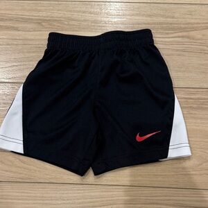 Nike Kids Black Shorts with Red Swoosh